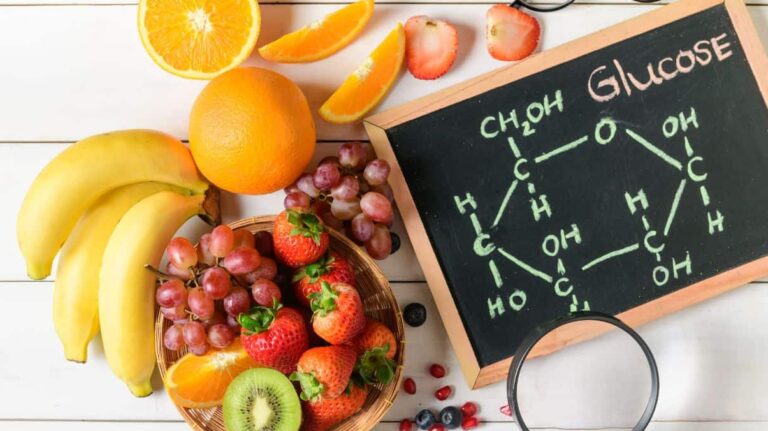 Image of banana, orange and other fruit and glucose molecule.